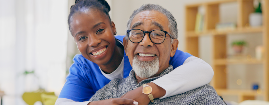 Life Assure Senior Woman Sitting In Chair And Laughing With Caregiver Nurse Hero